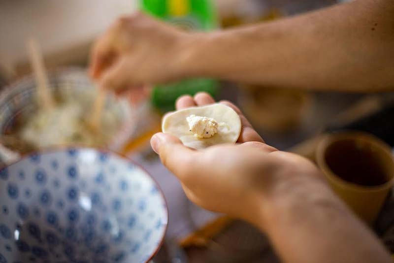 placing the filling into the pierogi